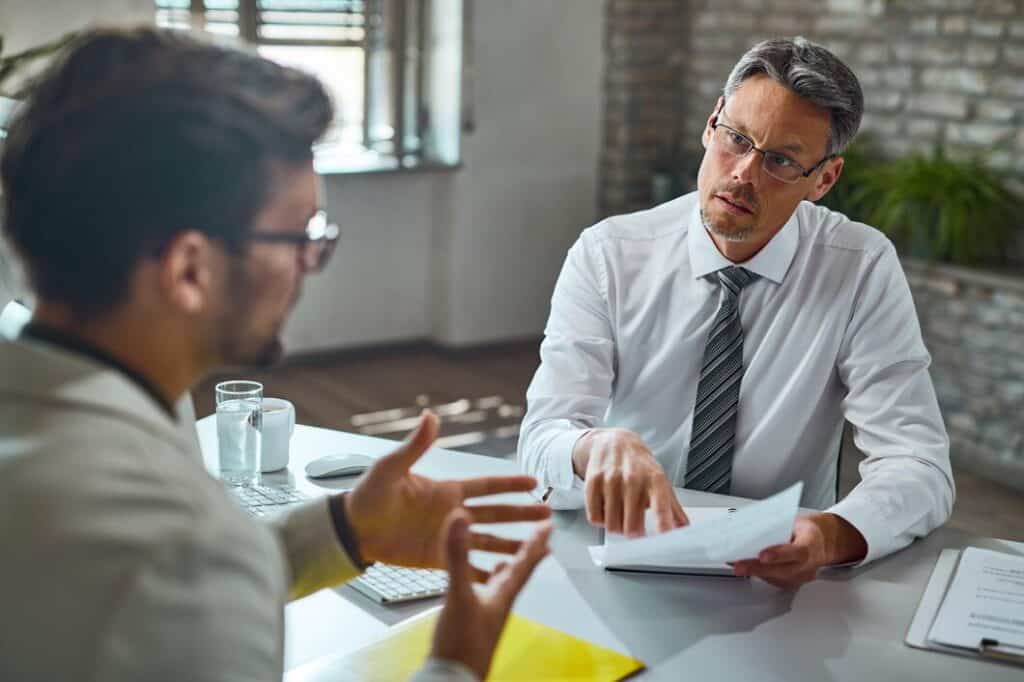 member-human-resource-team-talking-with-candidate-while-reviewing-his-resume-job-interview-office_637285-6535