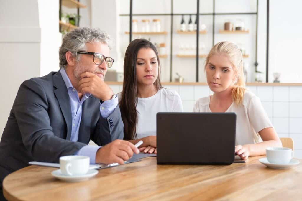 young-entrepreneurs-showing-presentation-mature-investor